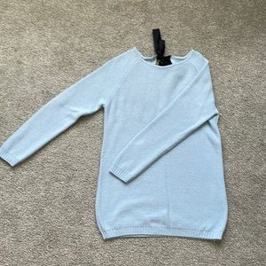 Cute light blue sweater with a bow in the back.